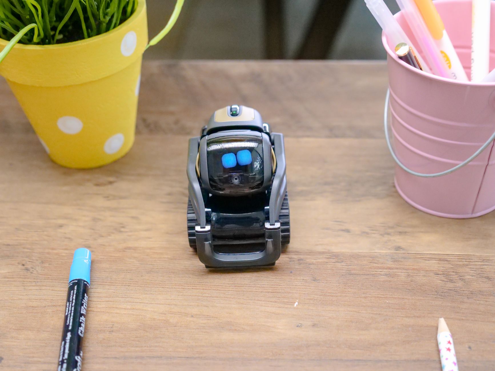 A robot and human collaborate on a laptop, symbolizing AI content creation.