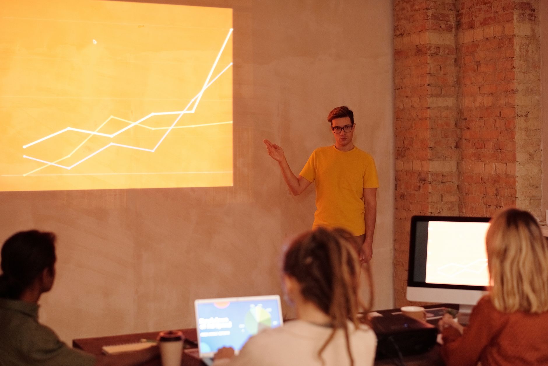 A person looking at a screen with graphs and data, representing a SaaS SEO platform demo.